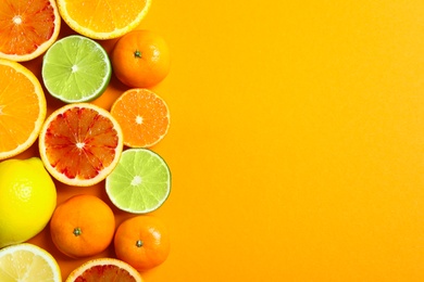 Photo of Different citrus fruits on color background, flat lay. Space for text