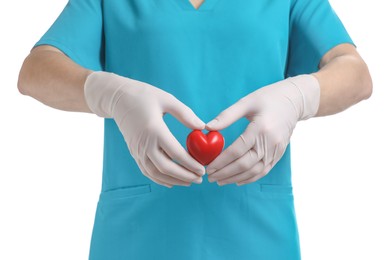 Photo of Doctor in medical gloves holding red heart on white background, closeup