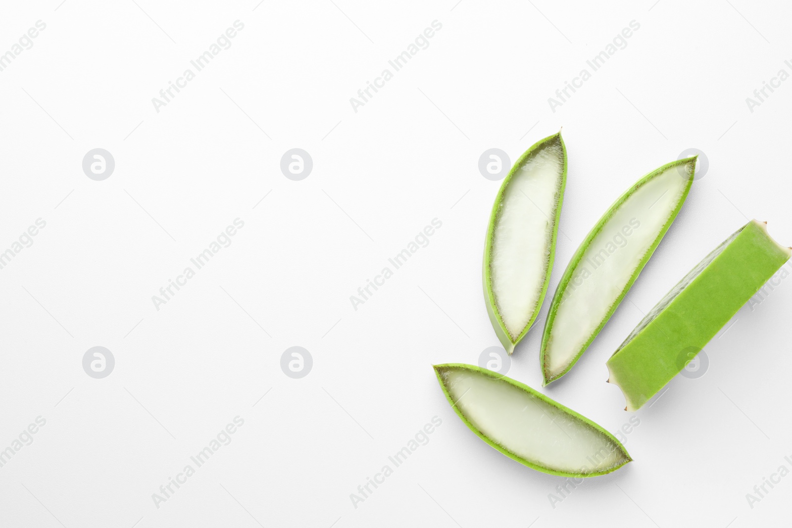 Photo of Fresh aloe vera pieces on white background, flat lay. Space for text