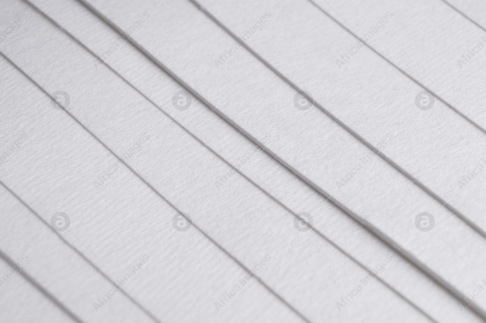 Photo of Many sheets of watercolor paper as background, closeup