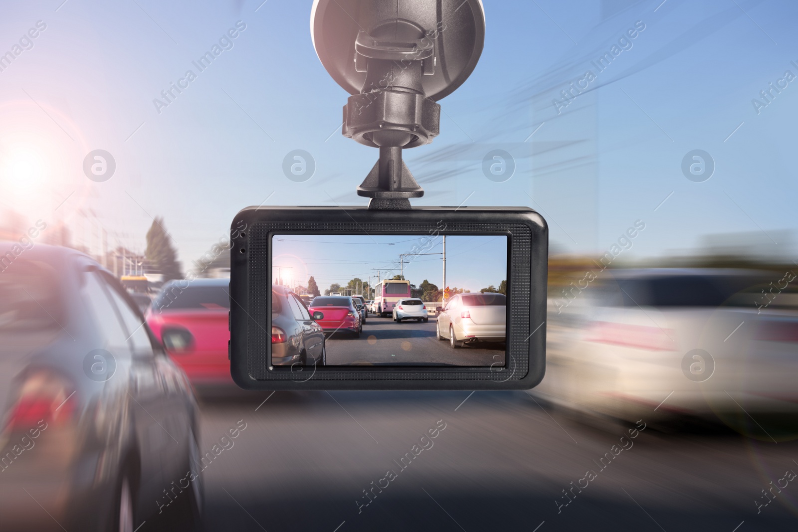 Image of Modern dashboard camera mounted in car, view of road during driving