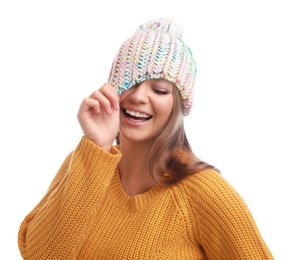 Photo of Funny young woman in warm sweater and hat on white background. Winter season