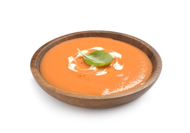 Photo of Tasty creamy pumpkin soup with basil in bowl on white background