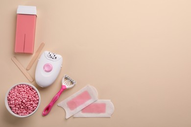 Photo of Set of epilation products on beige background, flat lay. Space for text