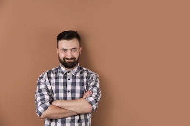 Photo of Portrait of handsome bearded man on color background