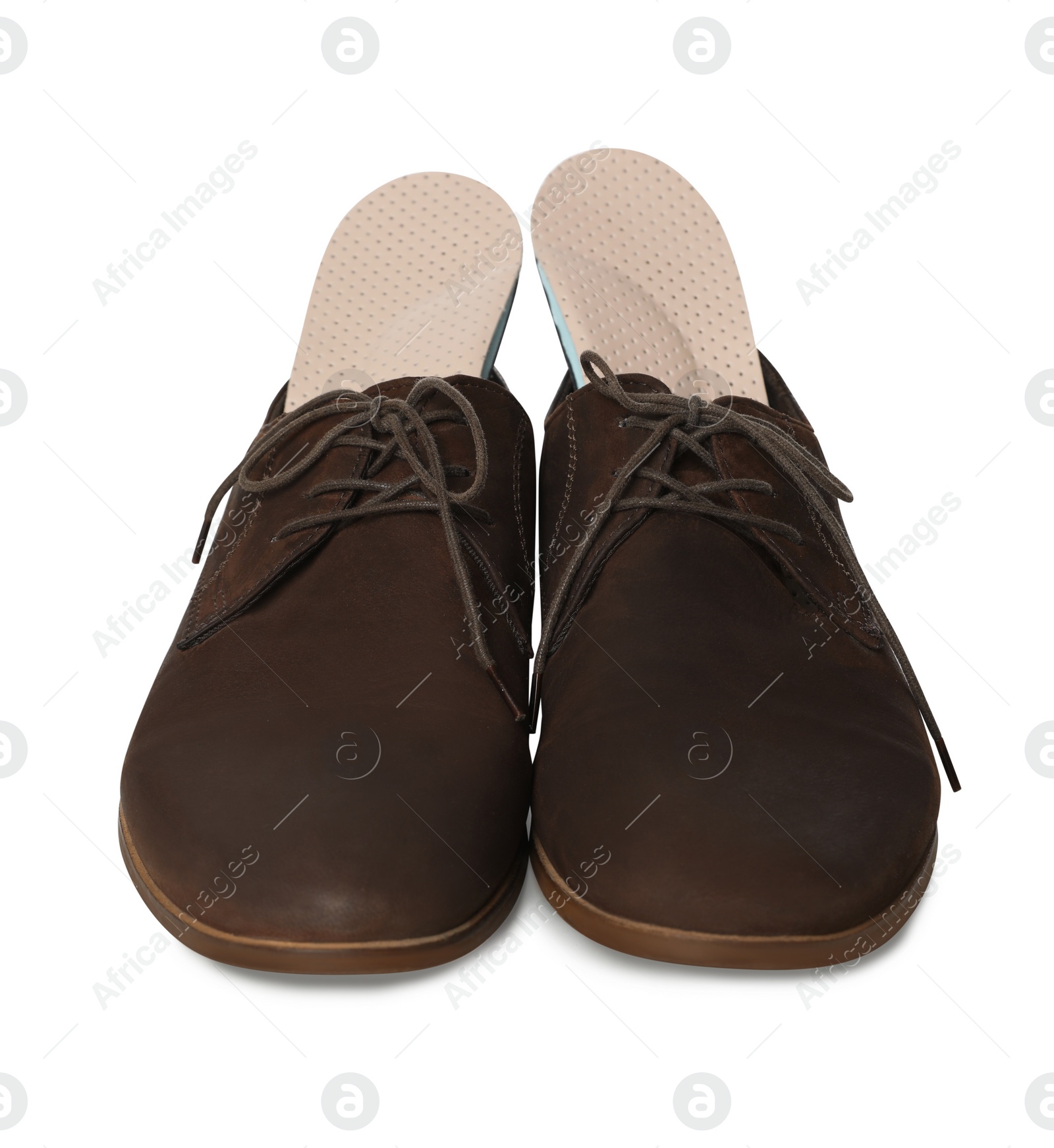 Photo of Orthopedic insoles in shoes on white background