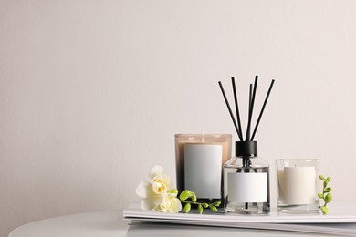 Photo of Composition with aromatic reed air freshener on white table, space for text