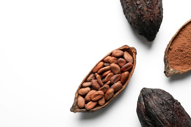 Photo of Cocoa pods with beans and powder on white background, top view