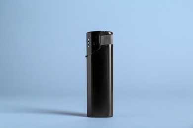 Photo of Stylish small pocket lighter on white background