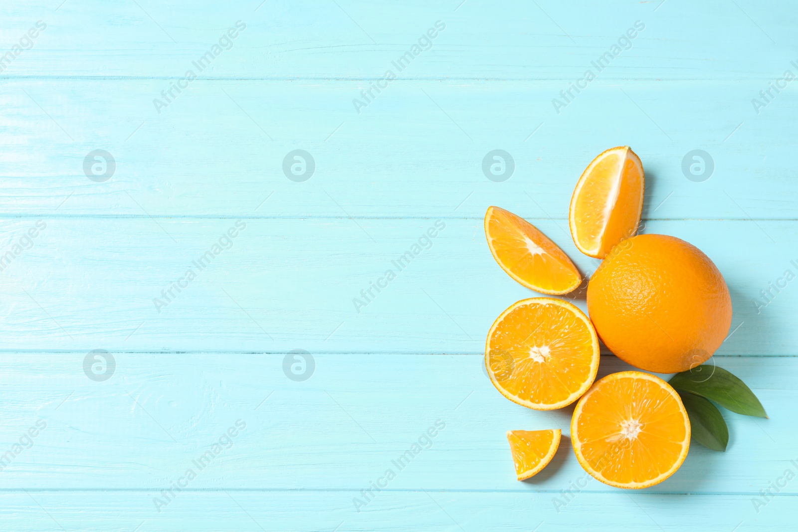 Photo of Flat lay composition with fresh oranges on wooden background. Space for text