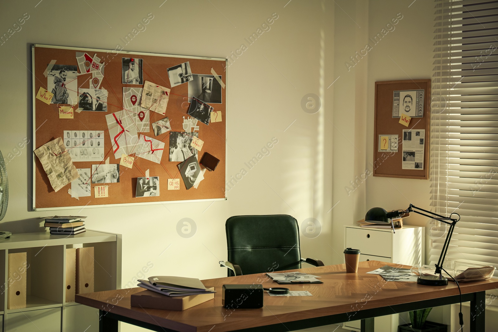 Photo of Detective workplace and evidence board in modern office