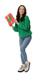 Beautiful young woman with Christmas gift isolated on white