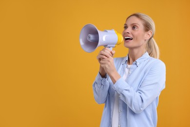 Photo of Special promotion. Woman shouting in megaphone on orange background. Space for text