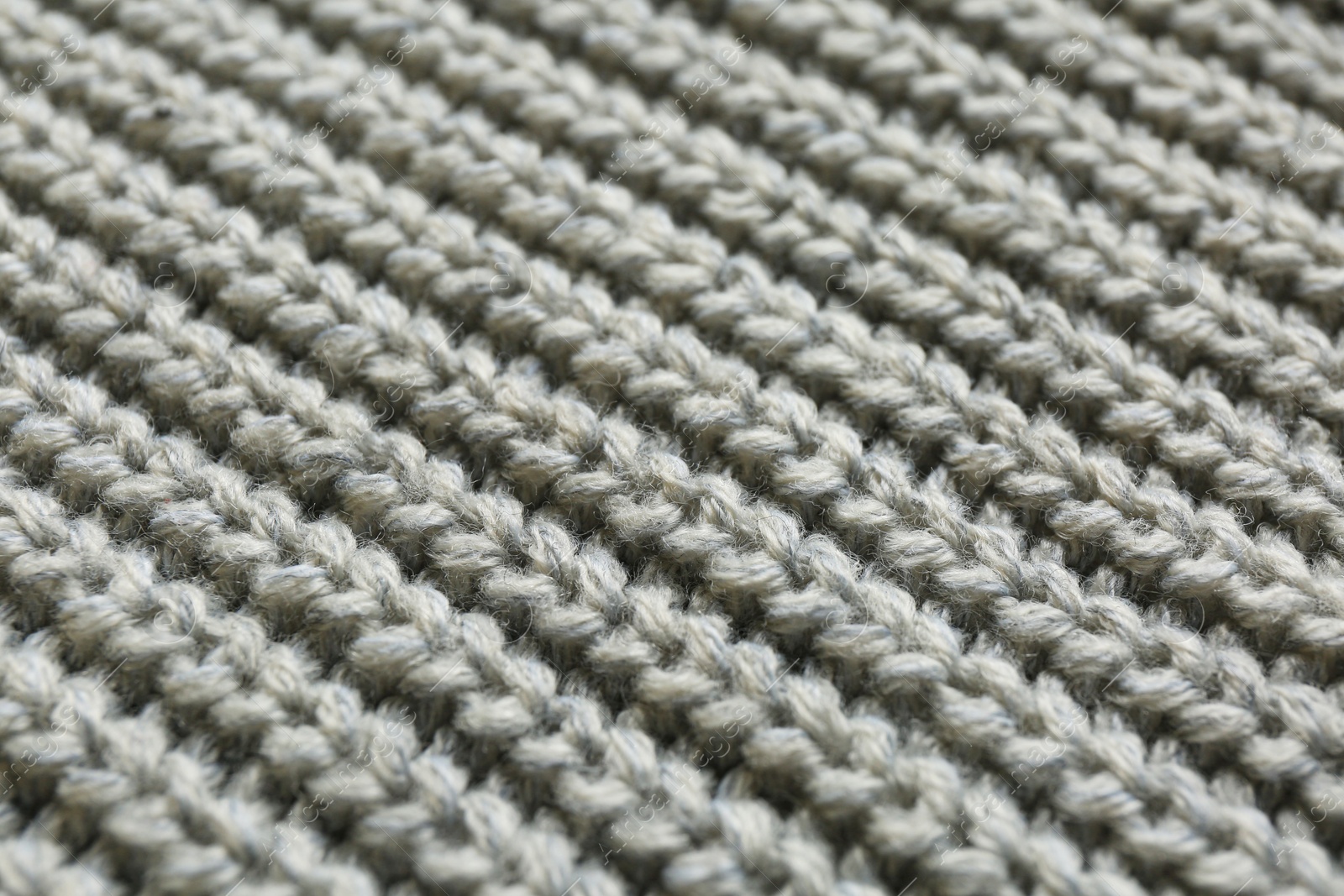 Photo of Beautiful grey knitted fabric as background, closeup