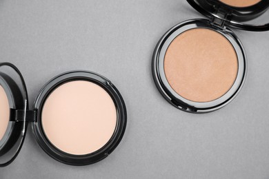 Open face powders on light grey background, flat lay