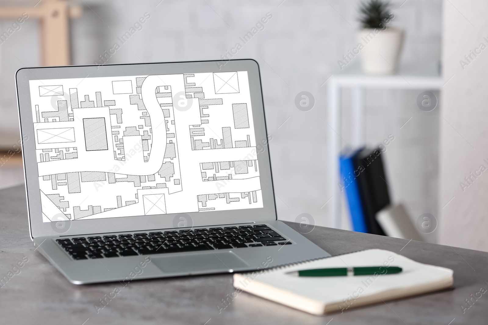 Image of Modern laptop with cadastral map on screen in office 