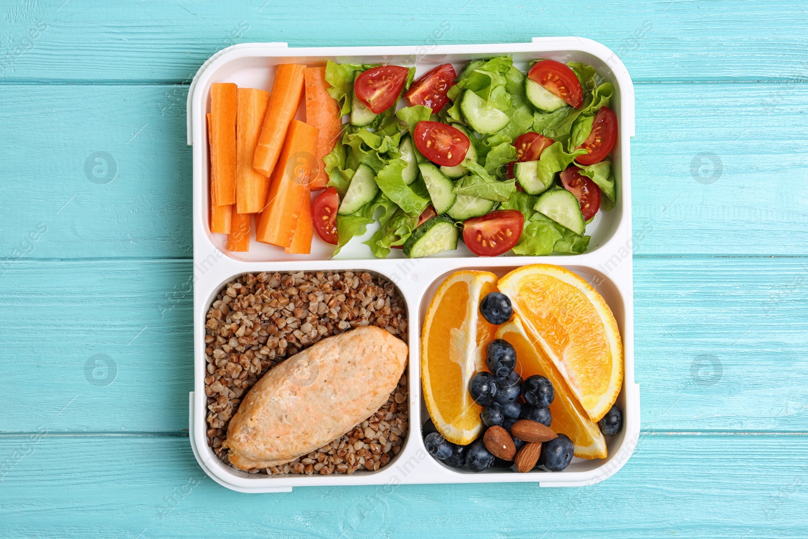 Photo of Tray with healthy food for school child on light blue table, top view