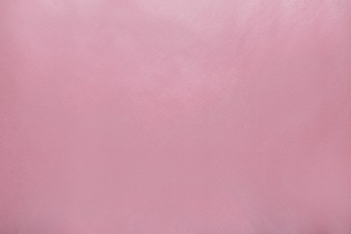 Pink wrapping paper as background, top view