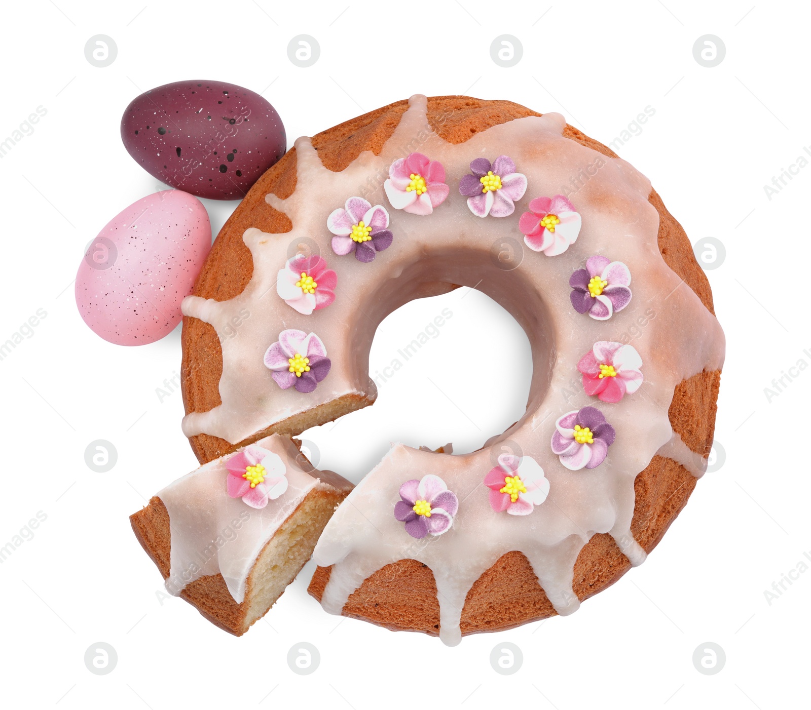 Photo of Festively decorated Easter cake and painted eggs on white background, top view