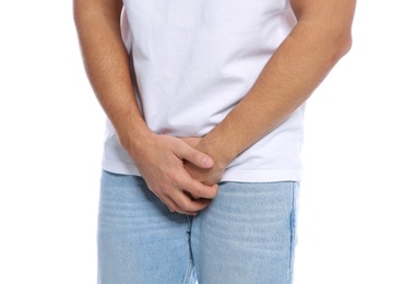 Photo of Man with itching crotch on white background, closeup