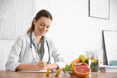 Photo of Female nutritionist working at desk in office