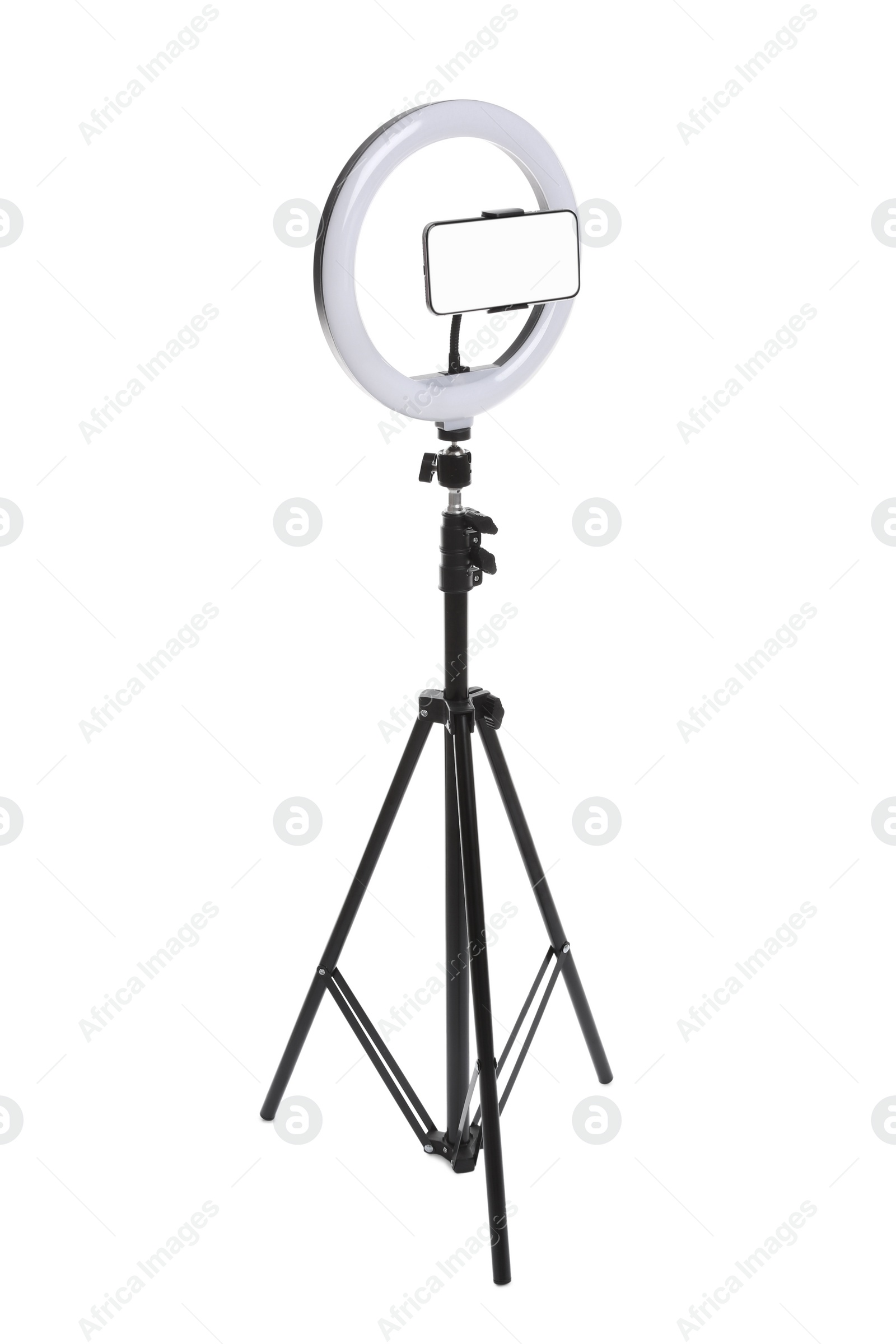 Photo of Modern tripod with ring light and smartphone isolated on white