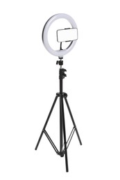 Modern tripod with ring light and smartphone isolated on white