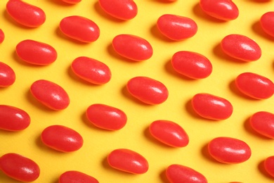 Photo of Flat lay composition with delicious jelly beans on color background