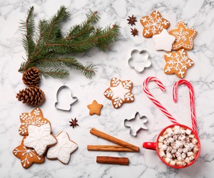 Flat lay composition with decorated Christmas cookies on white marble table