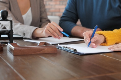 Photo of Female notary working with mature couple in office, closeup