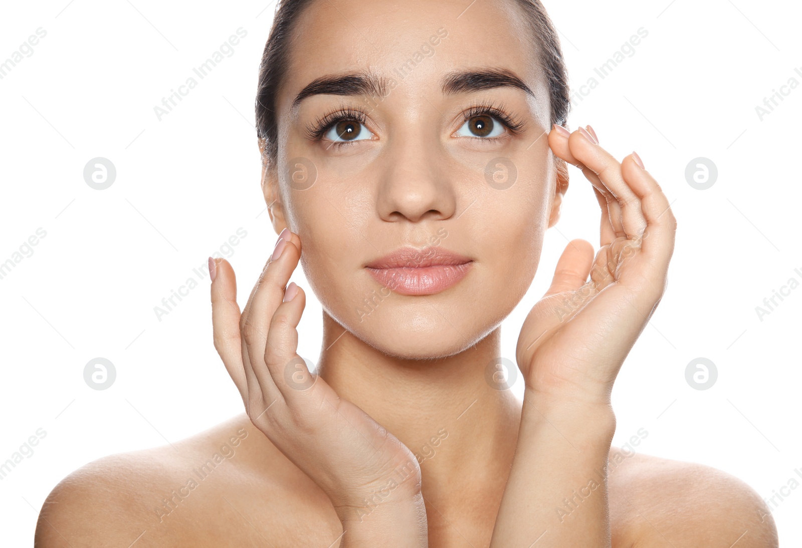 Photo of Portrait of young woman with foundation on her face against white background