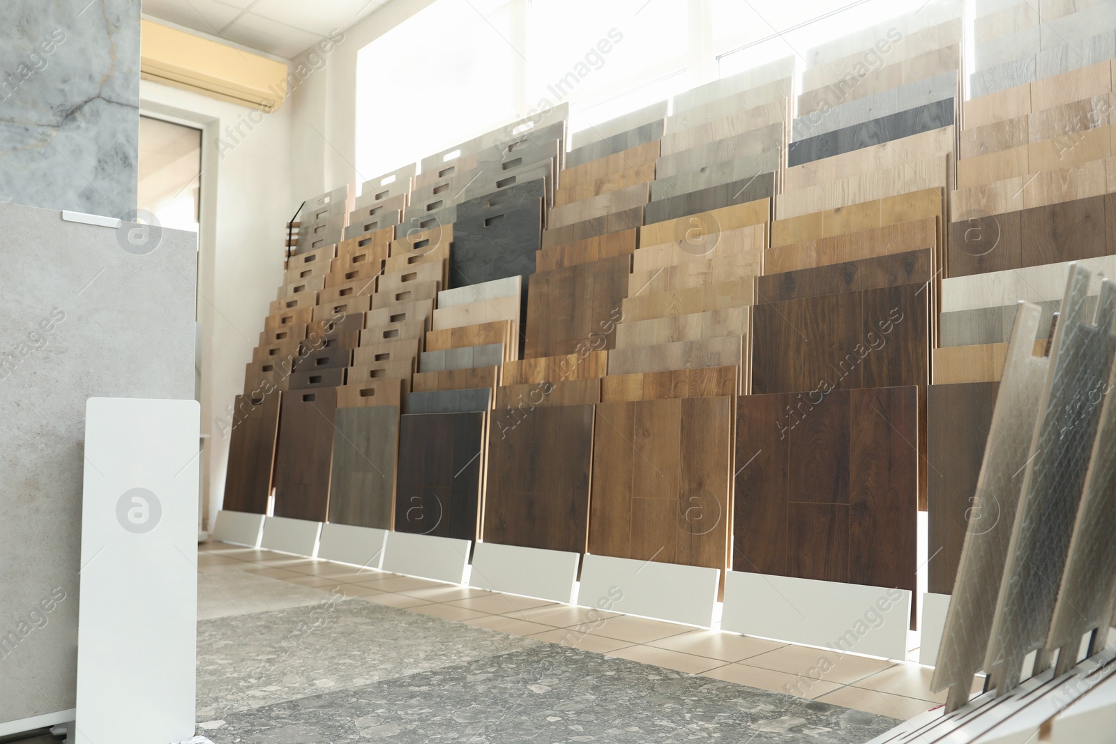 Photo of Assortment of tiles in store. Many different samples indoors