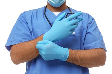 Doctor putting on medical gloves against white background, closeup