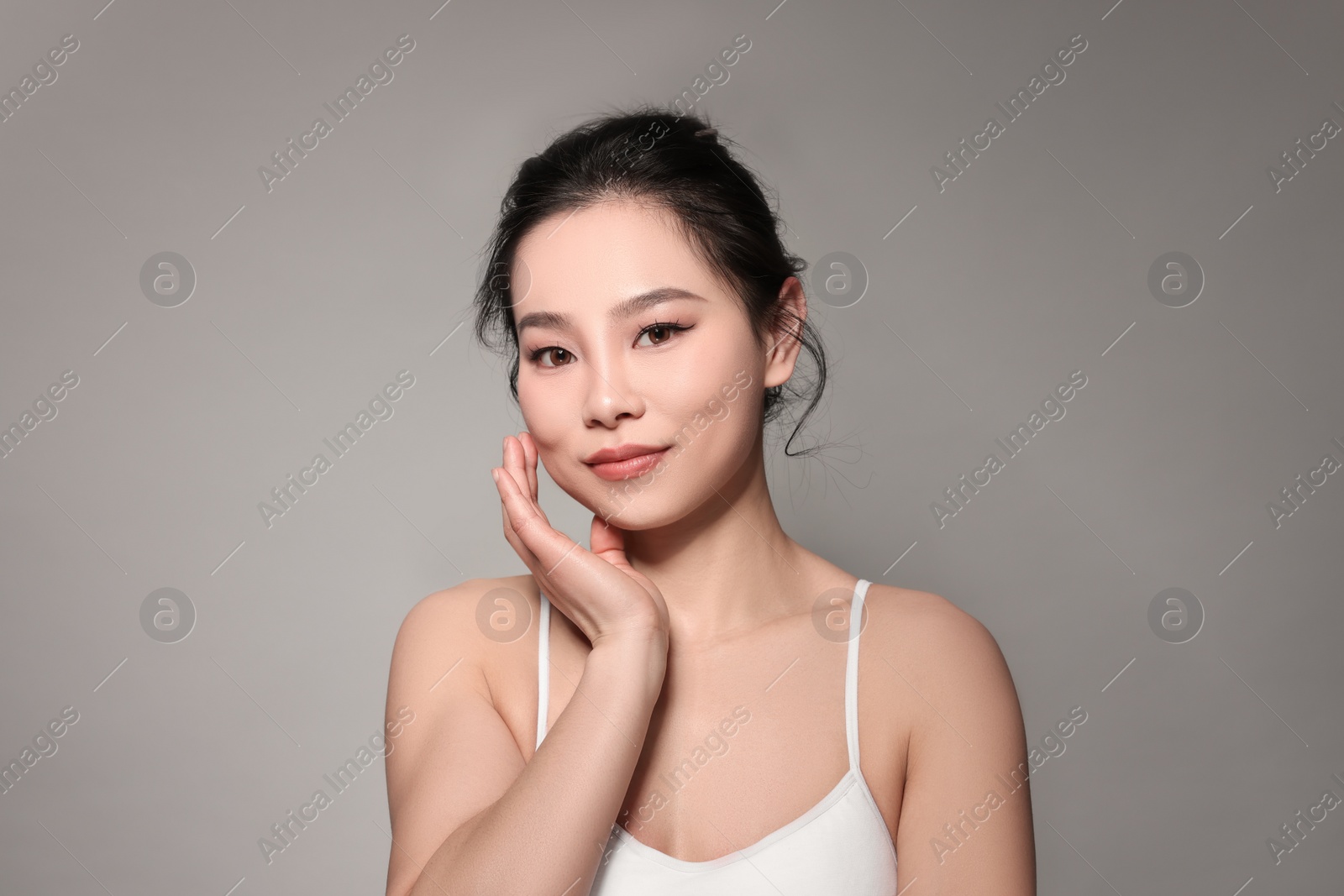 Photo of Portrait of beautiful woman on grey background