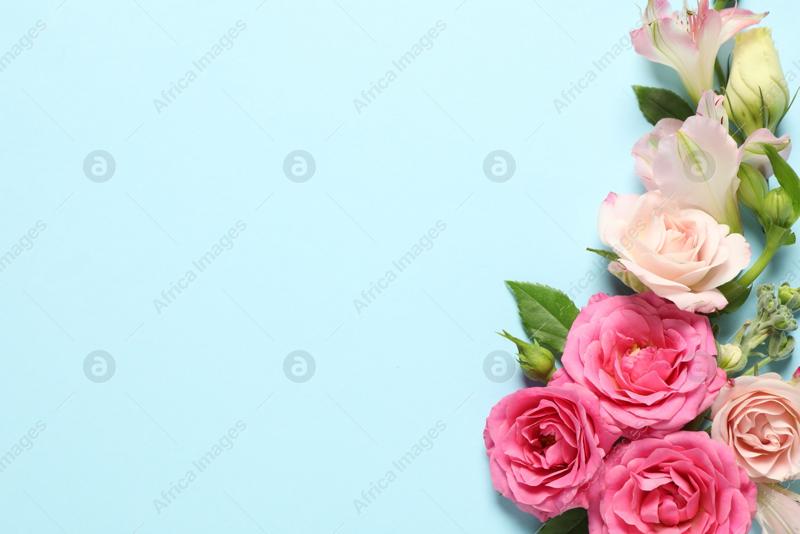 Photo of Happy Mother's Day. Beautiful flowers on light blue background, flat lay. Space for text