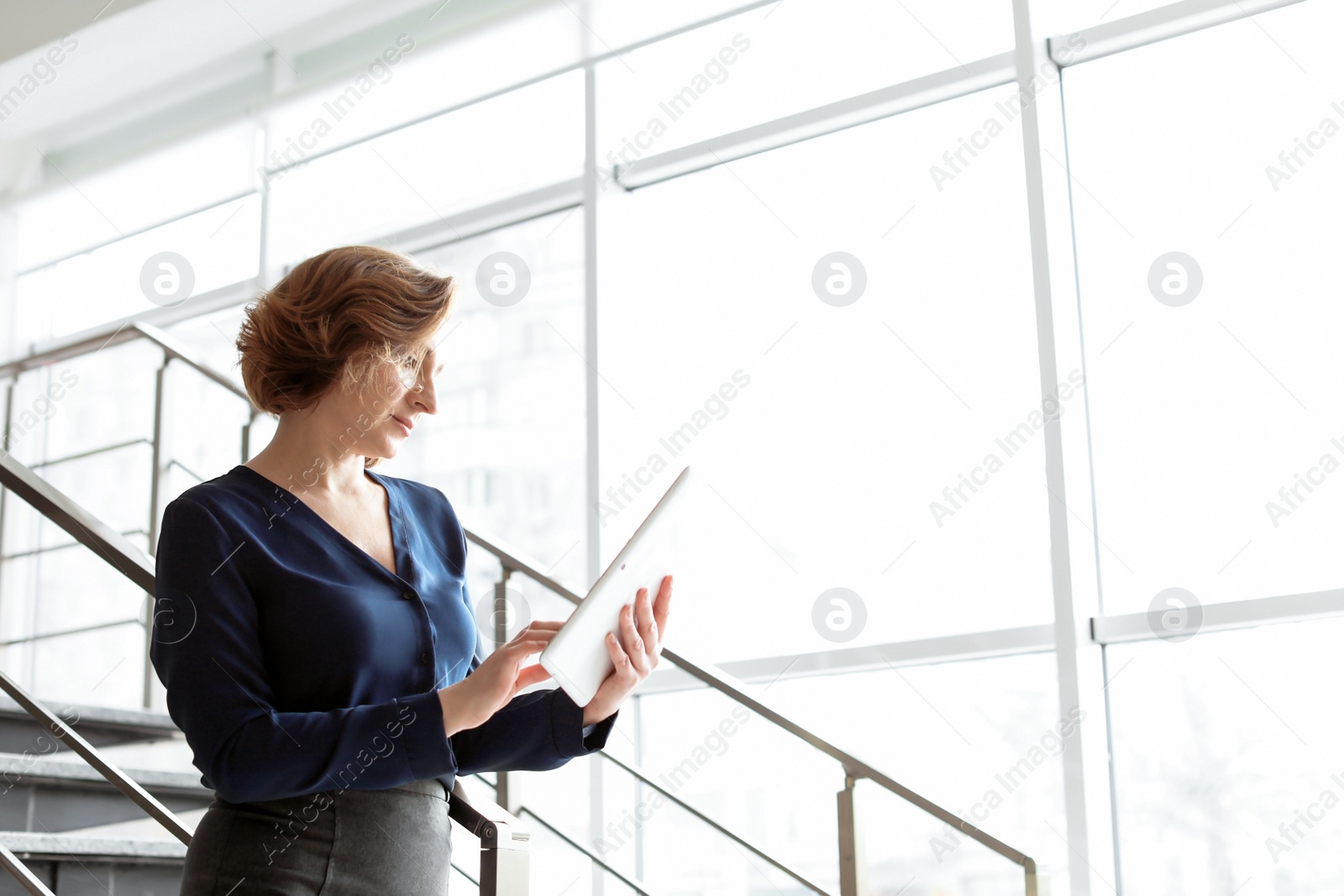 Photo of Female lawyer working with tablet in office