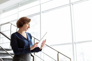 Photo of Female lawyer working with tablet in office