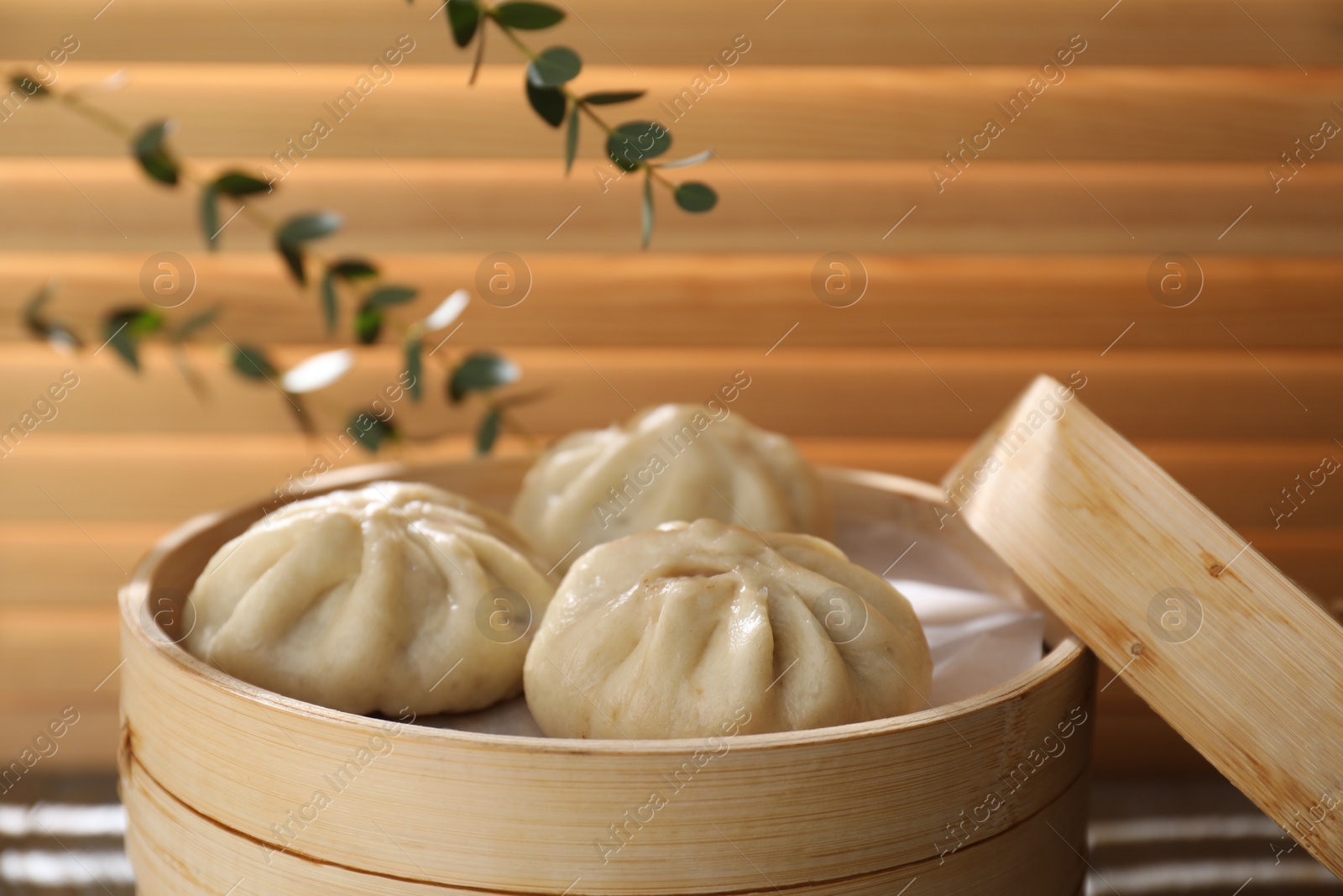 Photo of Delicious bao buns (baozi) on table, closeup