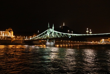 Photo of BUDAPEST, HUNGARY - APRIL 27, 2019: Beautiful night cityscape with illuminated Liberty Bridge across Danube river