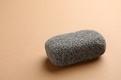 Photo of Pumice stone on brown background. Pedicure tool
