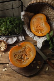 Photo of Cut fresh ripe pumpkin on wooden table