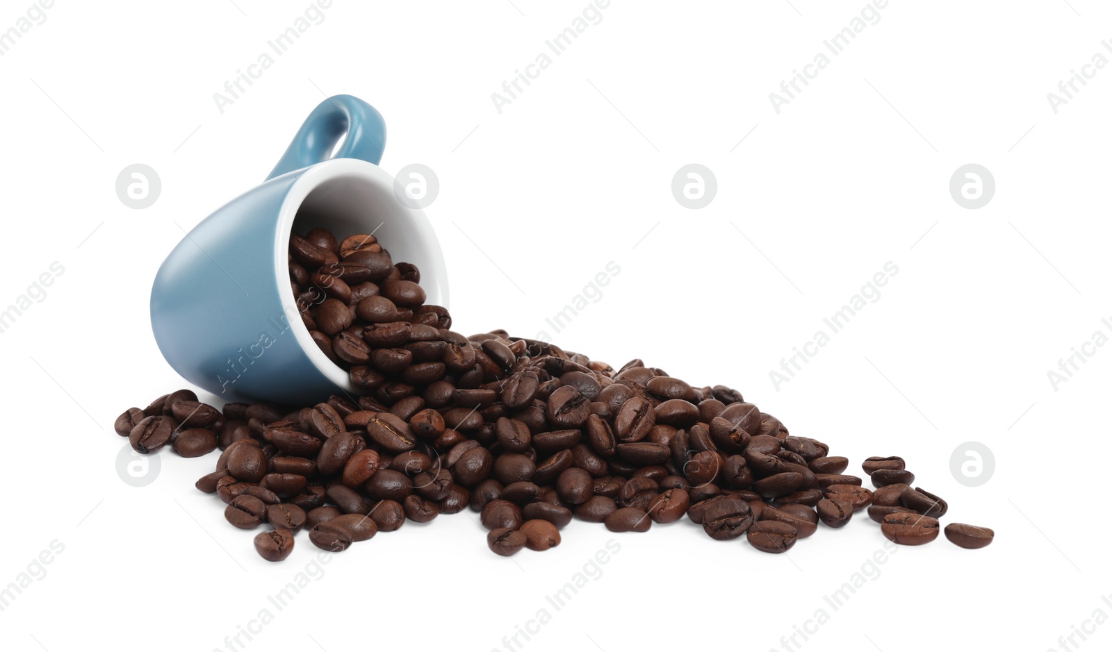 Photo of Coffee beans and overturned light blue cup isolated on white