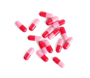 Photo of Many pink pills isolated on white, top view