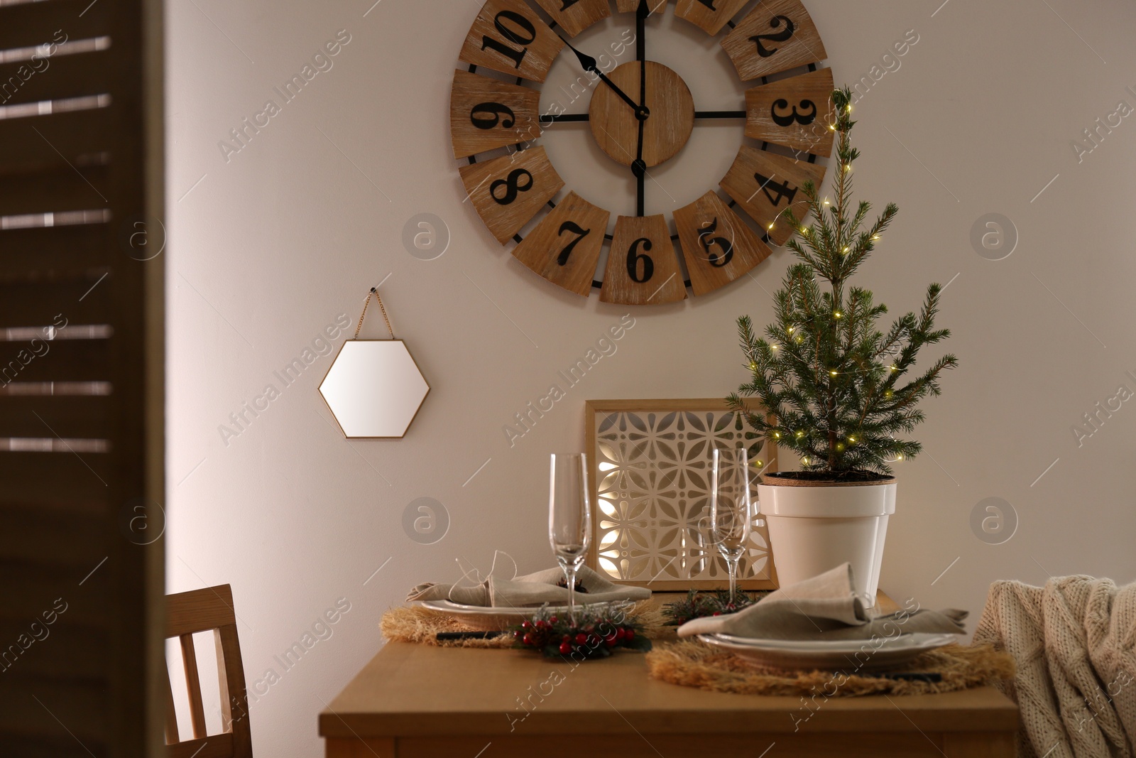 Photo of Small potted fir tree on dining table indoors. Interior design