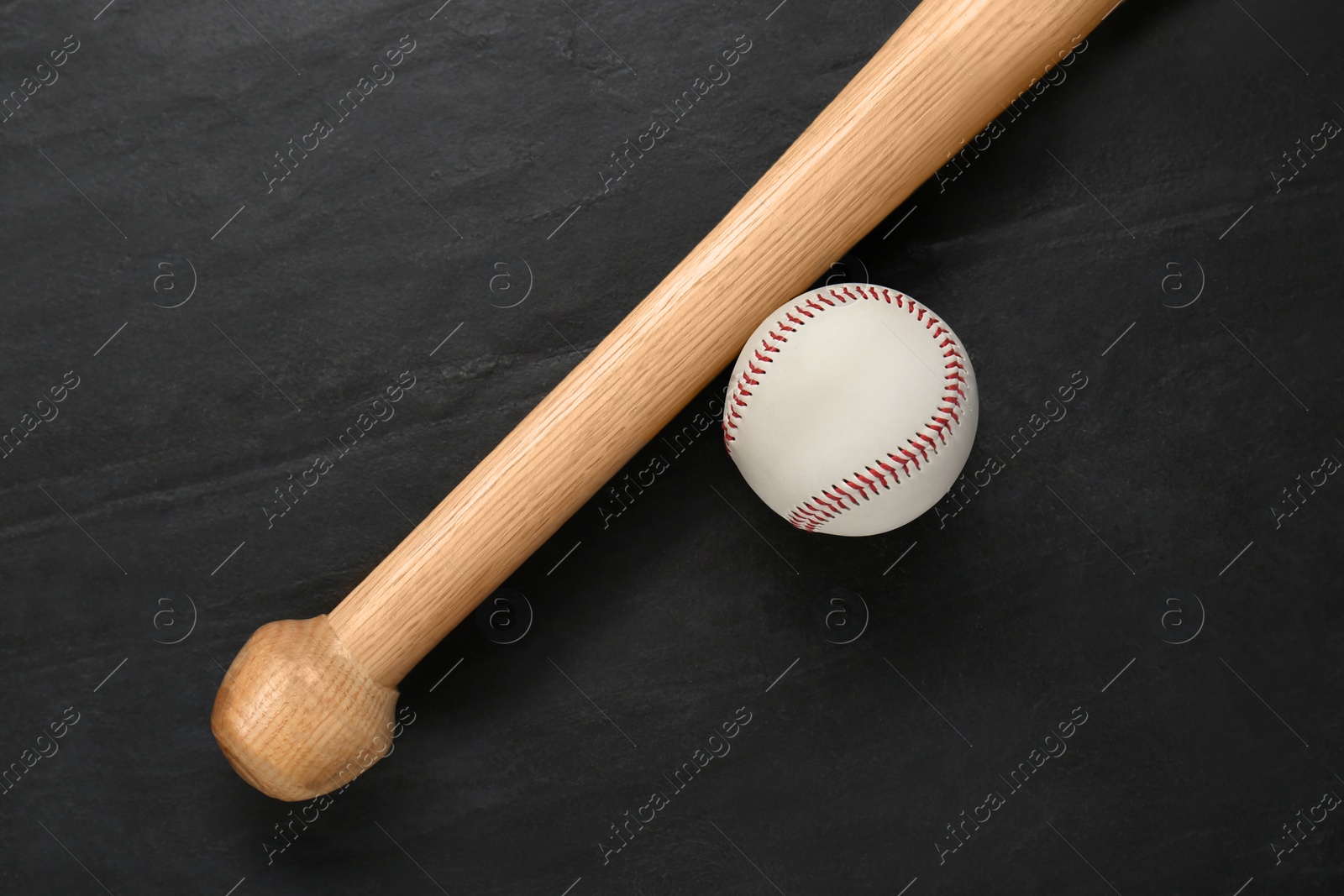 Photo of Baseball bat and ball on black background, top view. Sports equipment