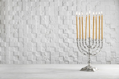 Photo of Hanukkah menorah on table against white background