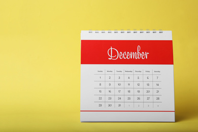 Paper calendar on yellow background, space for text. Planning concept