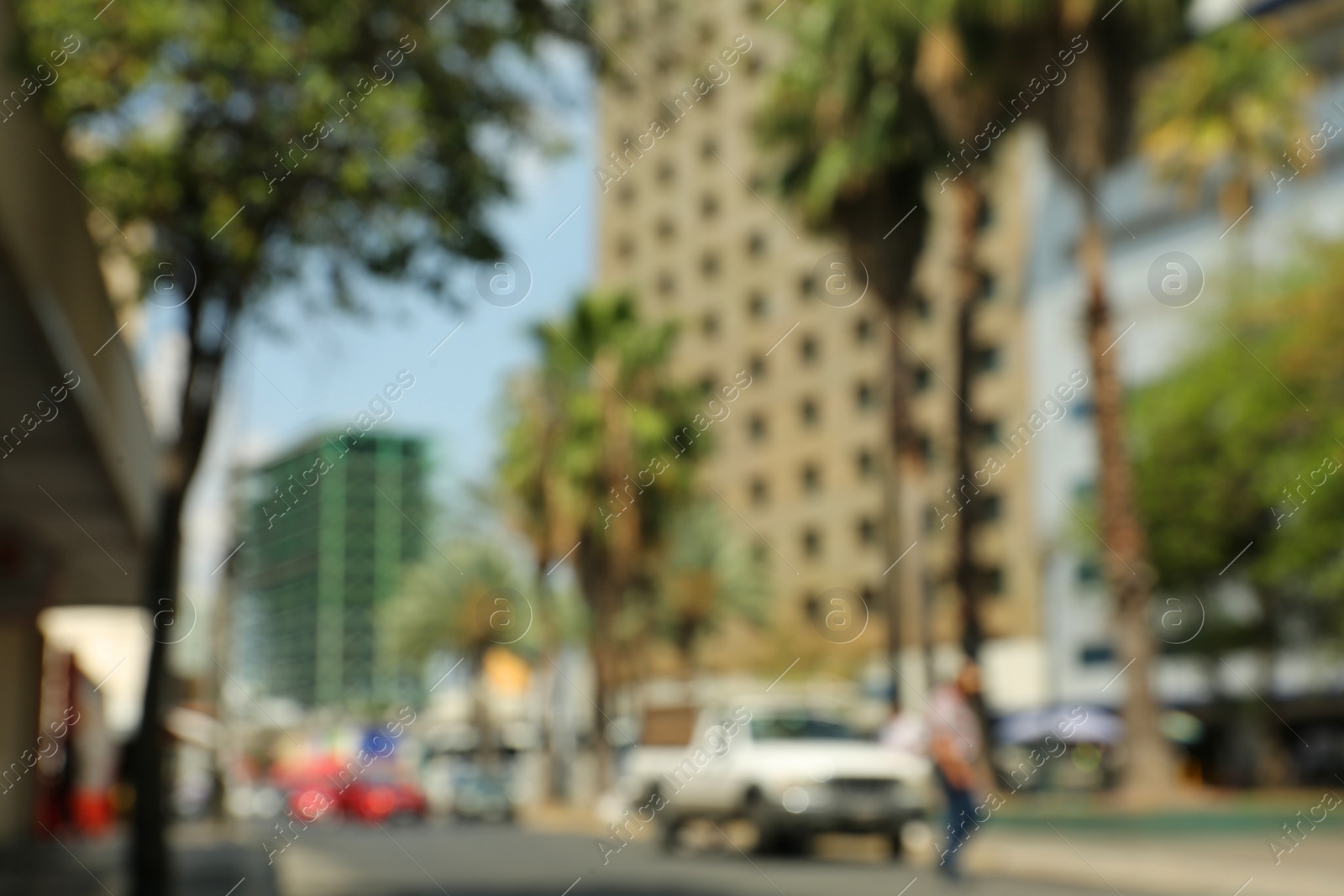 Photo of Blurred view of city street with cars