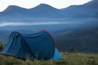 Photo of Camping tent in mountains on early morning