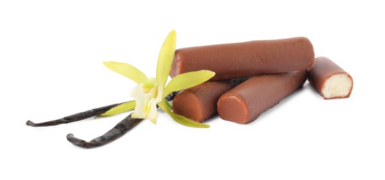 Photo of Glazed curd cheese bars, vanilla pods and flower isolated on white